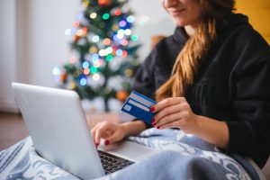female holiday shopping online with a credit card