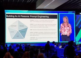 A conference with an image of a slideshow and a woman speaking projected onto a large screen.