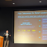 Rich Mendolora speaking in front of his slide Four Takeaways for Retail Leaders